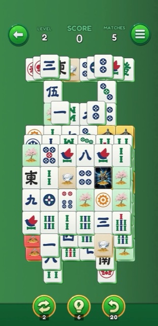 Gameplay screenshot of a full mahjong board with colorful tiles